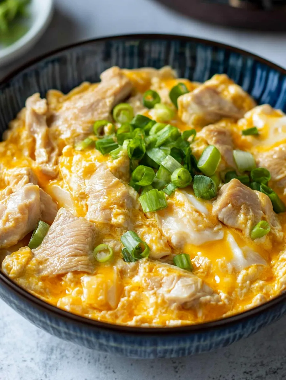 Un bol d'oyakodon, un plat japonais préparé avec du poulet et des légumes.